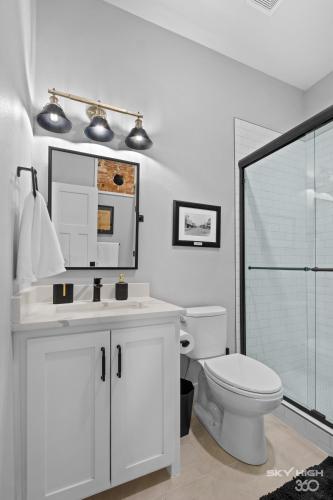 a bathroom with a toilet and a sink and a mirror at The Price House in Springdale