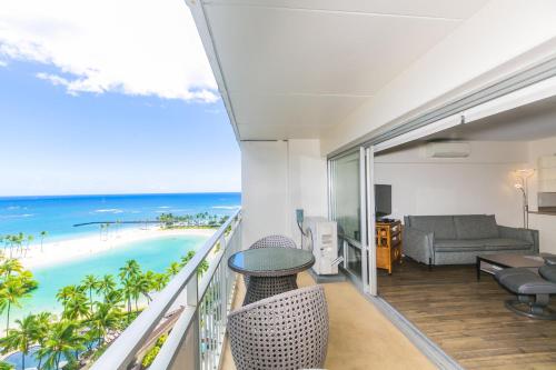 a room with a balcony with a view of the beach at Ilikai Tower 1340 Lagoon View 1BR in Honolulu