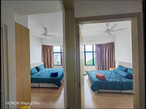a bedroom with a bed and a mirror at Mutiara Melaka Beach Resort Condominium,Pantai Puteri Melaka in Melaka