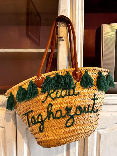 a wicker bag with a sign that says vacation out at Nizar Surf Morocco in Taghazout
