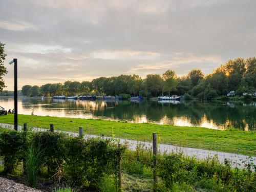 a view of a river with boats in it at Stylish Loft with Sauna in Antoing