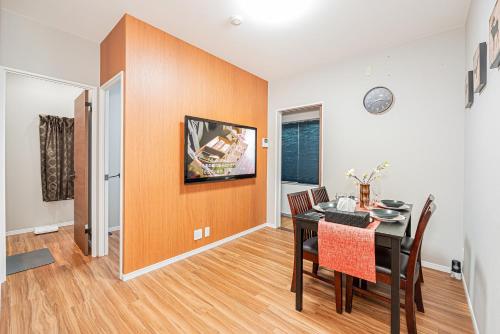 a dining room with a table and a room with a wall at Ueno Park Asakusa Temple Ueno Family Inn in Tokyo