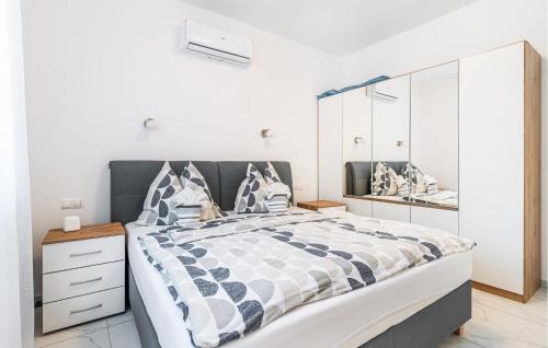 a bedroom with a large bed and a mirror at Amazing Apartment In Nedescina in Nedeščina