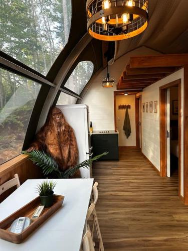 a room with a table and a refrigerator in a house at Sunken Escapes Glamping Unit #2 in New Minas