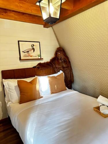 a bedroom with a white bed with a head board at Sunken Escapes Glamping Unit 5 in New Minas