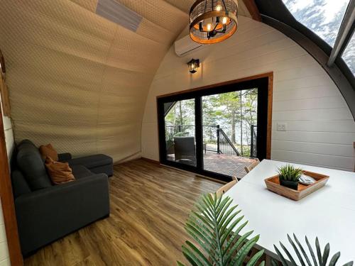 a room with a couch and a chair in a house at Sunken Escapes Glamping Unit 5 in New Minas