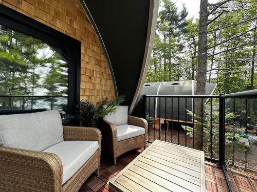 a screened in porch with a couch and a table at Sunken Escapes Glamping Unit 5 in New Minas
