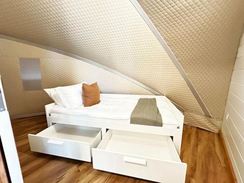 a small bed in a room with a wall at Sunken Escapes Glamping Unit 5 in New Minas