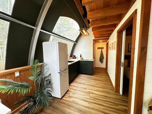 a kitchen with a white refrigerator in a room at Sunken Escapes Glamping Unit 5 in New Minas