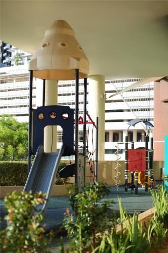 a playground with a slide in a building at Afiniti 2BR Sunlit Designer - 3 Min To Legoland in Iskandar Puteri