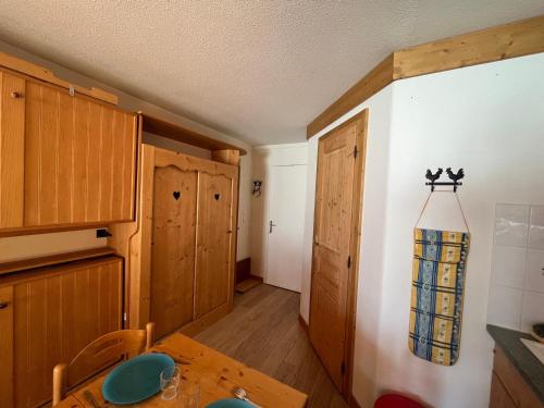 - une cuisine avec des placards en bois et une table dans une pièce dans l'établissement Appartement au cœur d'Avoriaz pour 4 pers, 22 m² - Village du Festival - FR-1-633-81, à Morzine