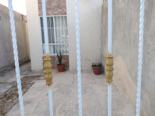 two white poles in front of a building at Turquoise Comfort Haven in Cancún