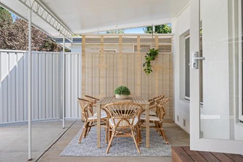 a dining room with a table and chairs on a patio at Frankie's Place- lux & stylish in Wodonga