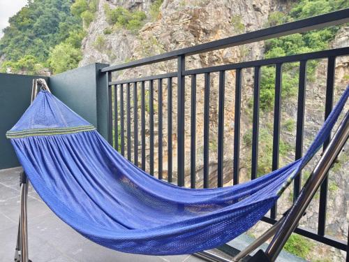 a blue hammock on a balcony with a view at The Cove Hillside Ipoh by Glex in Ipoh