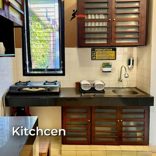 a kitchen with a sink and a counter top at Sampai Villa Amarajota in Kejayan