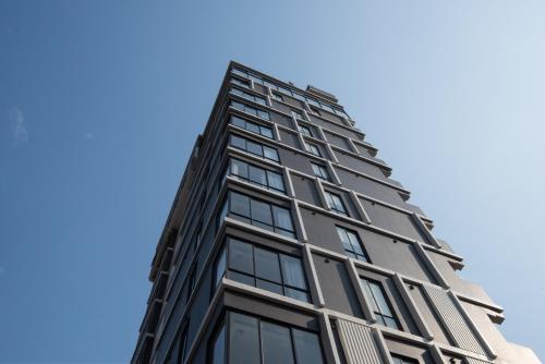 a tall black building against a blue sky at GLOW PARK HOTEL Grand Royal Palace in Phnom Penh
