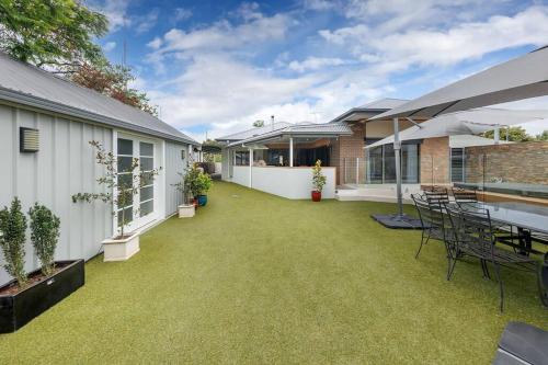 an outdoor patio with a table and chairs at Central Entertainer's Paradise in Wodonga