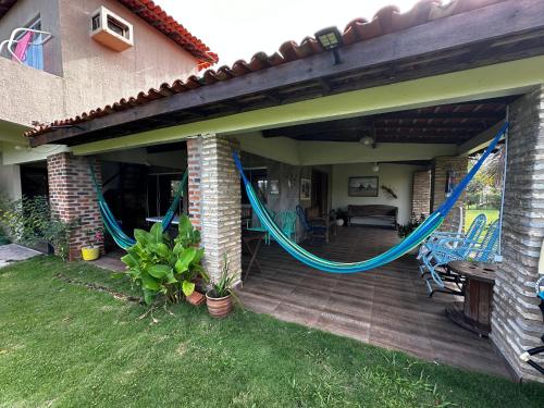 a patio with a hammock on a house at Sítio Encanto do Delta in Tutóia
