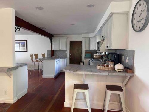 a kitchen with a counter and a clock on the wall at Malibu Ocean Villa with King Bed, Hot Tub, Beach, BBQ in Malibu