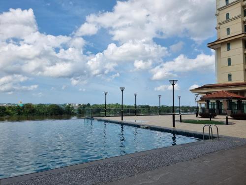 a large pool of water in front of a building at Blue Cove Riverine Diamond Kuching in Kuching