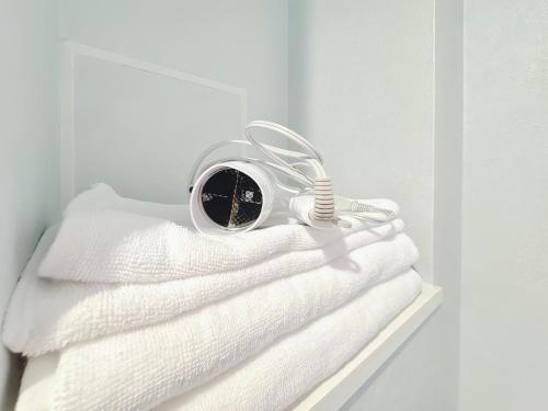 a bunch of white towels sitting on a shelf at Juso AFP Apartment Hotel in Osaka