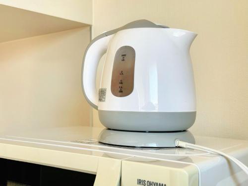 a white blender sitting on top of a shelf at Juso AFP Apartment Hotel in Osaka