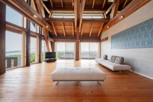 a large living room with a couch and a tv at 日本の松を贅沢に使った特別感のある別荘 Lemon villa in Fukuoka