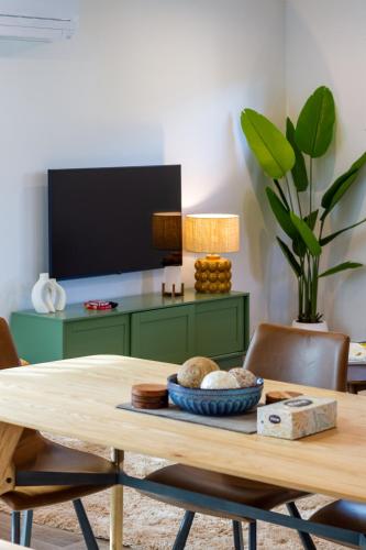 a dining room with a table with a green cabinet at Spacious Stay near Avon River with Carpark in Linwood