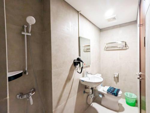 a bathroom with a toilet and a sink and a shower at Lovina 12- 20 at Pollux Meisterstadt in Batam Center
