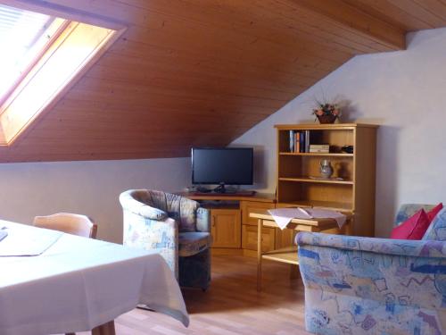 a living room with two chairs and a television at Giglerhof in Bad Birnbach