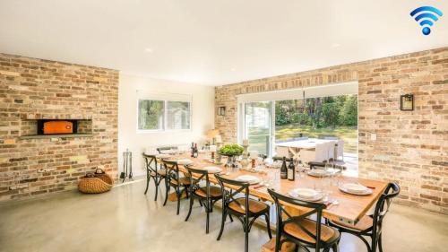 a large dining room with a long table and chairs at Amaroo in Bowral