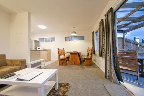 a living room with a couch and a table at The Olive Motel in Coromandel Town