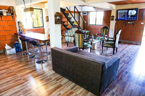 a living room with a couch and chairs and a table at Retro Finca Urrao - Peaceful Avocado Farm Retreat in Urrao