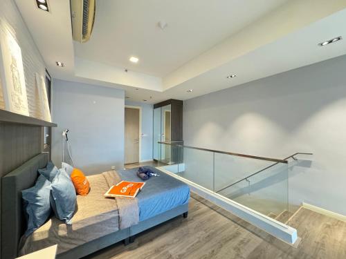 a bedroom with a bed and a glass wall at X - The Library Icon City Petaling Jaya Subang Airport in Sungai Way