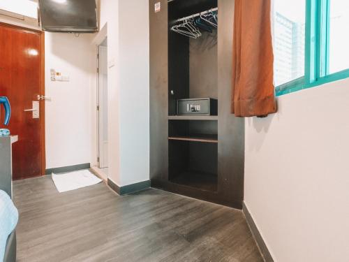a room with a closet with a wooden floor at A Hotel Desker in Singapore