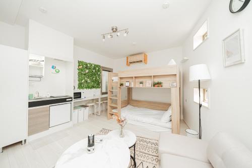 a small apartment with a bed and a kitchen at Momo-stay Ikebukuro in Tokyo