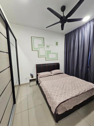 a bedroom with a bed and a ceiling fan at Bayu Temiang Residence - Cityscape Haven in Seremban