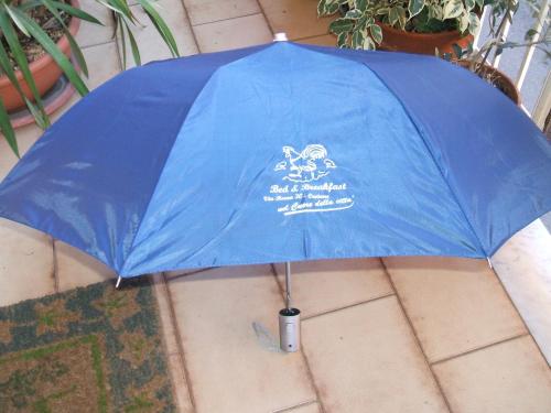 a blue umbrella is sitting on the ground at B&B Milu' in Crotone