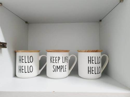 three coffee mugs sitting on a shelf in a room at Seoul House in Seoul