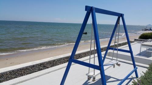 a blue ladder on a beach next to the ocean at The Crest Santora Huahin 4 Fl H(Monthly rate) in Hua Hin