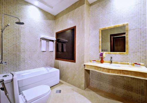 a bathroom with a white toilet and a sink at Luxury villas for rent in Jeddah