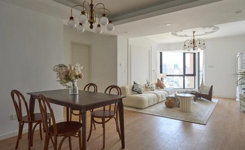 a living room with a table and a couch at Eastern Hub - Bund Branch Near Yuyuan Garden Convenient Subway in Shanghai
