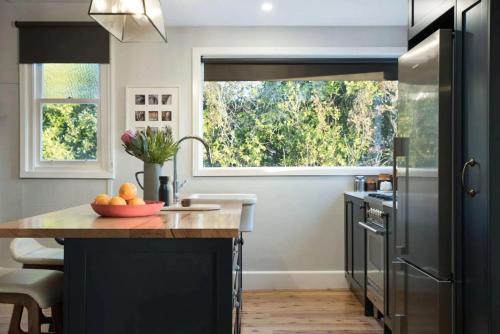 a kitchen with a counter with a sink and a window at The Arlow House in Daylesford