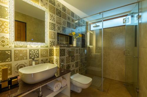 a bathroom with a sink and a shower and a toilet at ELIVAAS 3 BHK Pool & Bar - Villa Judiline in Goa