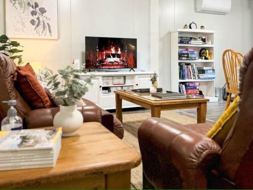 a living room with a couch and a table at The Hide, Bouvard in Dawesville
