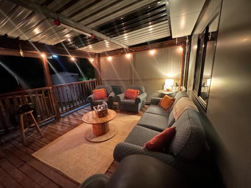a living room with a couch and chairs on a balcony at The Hide, Bouvard in Dawesville
