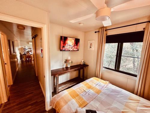 a bedroom with a bed and a window at The Hide, Bouvard in Dawesville