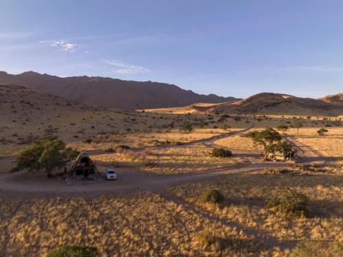 a small house in the middle of a desert at Camp Gecko - PRIVATE NATURE RESERVE; TENTED CAMP AND CAMPSITE in Solitaire