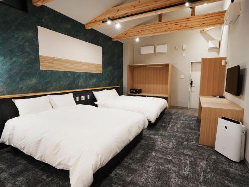 Postel nebo postele na pokoji v ubytování Hotel Soboku