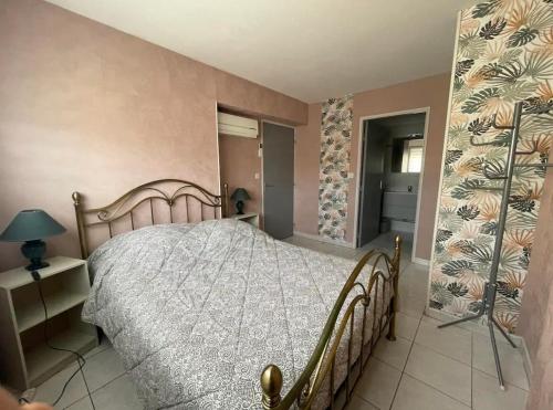 - une chambre avec un lit dans une pièce avec un mur dans l'établissement Yoyo's appart, à Perpignan